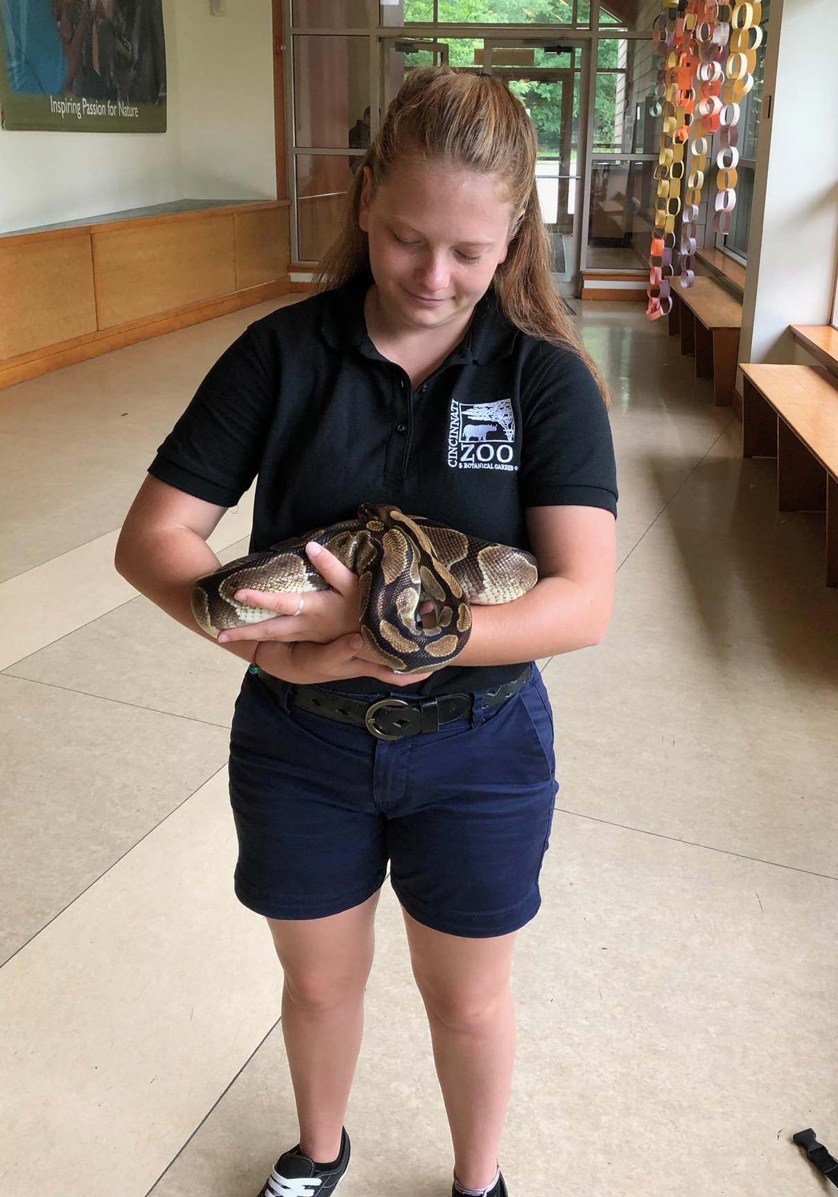 Kristina handling an animal from the education collection